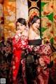 Two women in kimonos posing for a picture. 